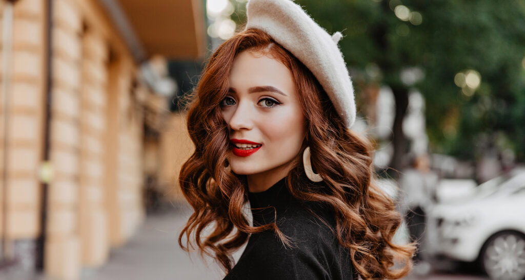 Jeune femme avec coloration aux couleurs d'automne dans ses cheveux réalisée par une coloriste du salon mixte Création Coiffure